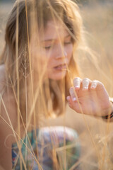 Natural Looking Young Beautiful Woman with Hazel eyes posing in the fields, no post editing