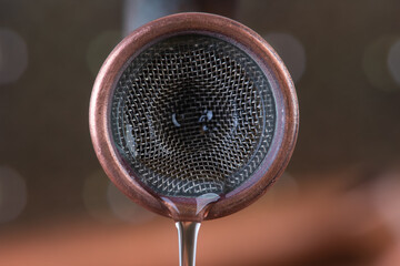 Copper tap with faucet aerator strainer and running water close-up
