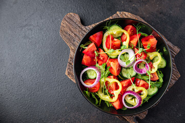 salad vegetables tomato, cucumber, pepper, onion, olive oil healthy food fresh portion veggie ready to eat meal snack on the table copy space food background rustic keto or paleo diet vegan