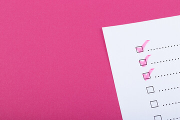 Check list with pink marked points on pink background