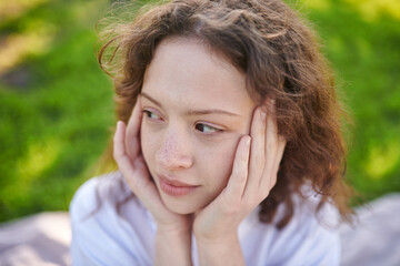 A waist up of a cute ginger girl