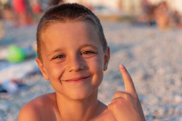 A nice boy on the beach at sunset