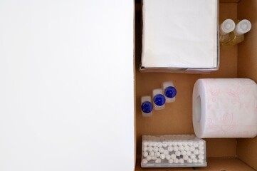 Personal hygiene products (toilet paper, napkins, antibacterial gel, Sanitizer, Cotton swab) in a box. Delivery of hygiene products.Humanitarian assistance.