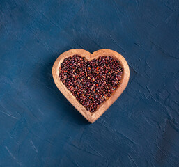 Chenopodium quinoa - Black quinoa seeds in a heart-shaped bowl
