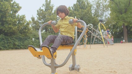 Active child in yellow shirt. Stimulate development through playground equipment. A well-designed...