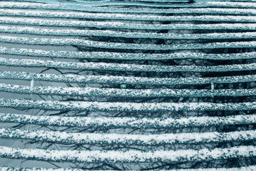 Ice melts on the rear window of the car - electric window heating with contact strips