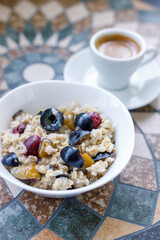 Breakfast background oatmeal with berries and coffee. Espresso with porridge for breakfast