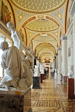 ST PETERSBURG, RUSSIA: Hermitage Museum - Gallery of the History of Ancient Paintings. White Greek and Roman neo-classical marble statues line the center. 80 paintings imitate ancient paintings