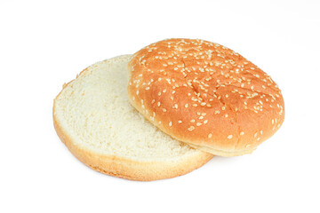 Two parts of sliced burger bun with sesame isolated on white background