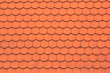 Red tiles on the roof, textured background for design. Old clay roof texture. Top view close-up
