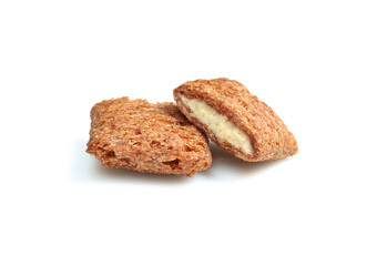 Crunchy chocolate pillows filled with milky cream isolated on white bbackground. Bitten treats