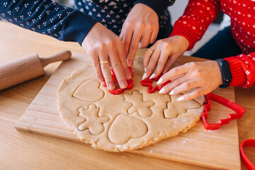 hands of two lovers man and woman making homemade cookies in the kitchen