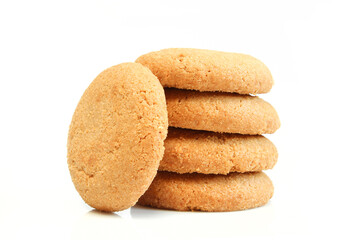 Pile of brown cookies isolated on white background