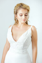 blonde caucasian bride on white dress