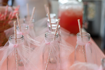 Festive decorated milk bottles for pink themed party