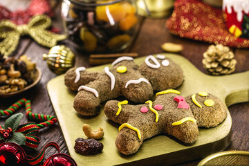 Gingerbread man, Christmas man cookie being covered and decorated by glace, twelve traditional Christmas