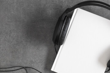Audio book concept. Headphones and books over stone table. Top view with space for your text © prime1001