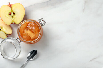 Delicious apple jam and fresh fruit on white table, flat lay. Space for text