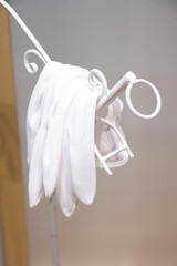 The groom's gloves are hung on the bouquet stand