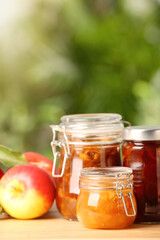 Delicious apple jams and fresh fruits on wooden table