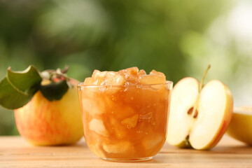 Delicious apple jam and fresh fruits on wooden table