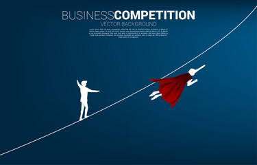 Silhouette of businessman flying compete with the man walking on rope.Concept for business risk and career path