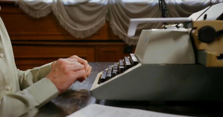 person working on typewriter