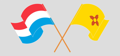 Crossed and waving flags of the State of New Mexico and Luxembourg
