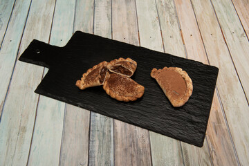 Argentine empanadas filled with milk chocolate and sprinkled with cocoa and sugar