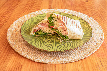 Wrap stuffed with chopped cooked ham with spinach, grated fresh cheese and dehydrated tomato