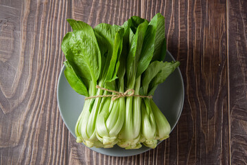 Pak Choi (Bok Choy) or Brassica chinensis green vegetable on wooden background