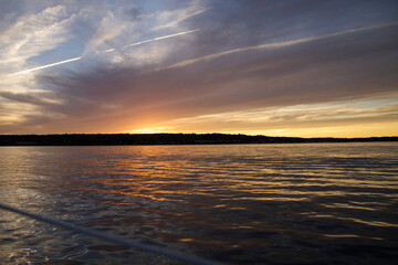 Obraz premium Beautiful sunset reflecting on the water while sailing at Narragansett Bay, Rhode Island USA