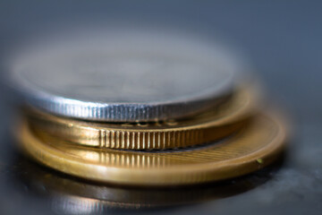 Close-up of gold and silver coins in common use.