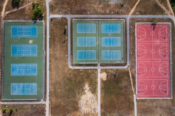 Drone view of empty basketball, tennis and volleyball courts