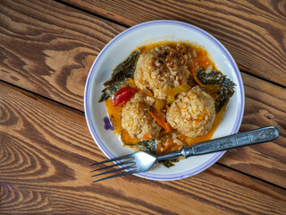 Lunch with chicken meatballs with rice and vegetables on a light plate