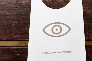Make up room signs are placed on wooden tables inside the hotel