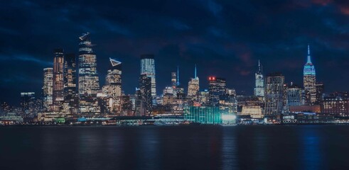 Fototapeta na wymiar new York city skyline at night beautiful reflections skyscrapers buildings sea 