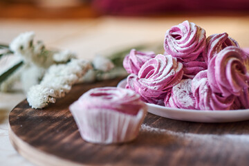 confectioner sprinkles icing sugar with dessert. Powder sugar falls on fresh perfect cupcakes or meringues