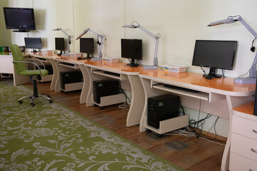 Modern coworking office. Conference table with office accessories and computers