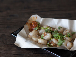 Hakka Abacus Seeds (Suan Pan Zi) Close Up. Chinese Gnocchi made of yam. Traditional Abacus Seeds on dark background with copy space.
