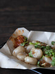 Hakka Abacus Seeds (Suan Pan Zi) Close Up. Chinese Gnocchi made of yam. Traditional Abacus Seeds on dark background with copy space.