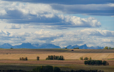 farmland and clouds over the mountains