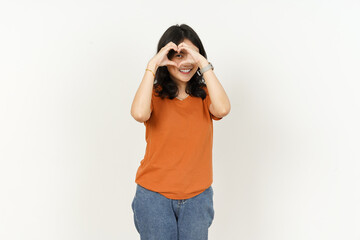 Beautiful Asian Woman Wearing Orange Color T-Shirt make and showing love heart hand sign Isolated On White Background