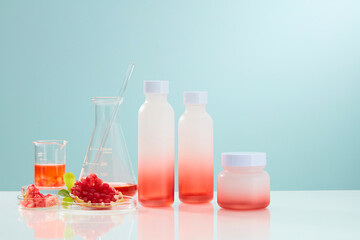 Chemical laboratory research with pomegranate extract and scientific glassware. Abstract cosmetic laboratory. Blank label package for branding mock-up.
