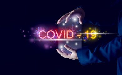 Fototapeta na wymiar Message COVID-19 coronavirus The word COVID-19 pandemic has hit the global economy and businesses with a new strain of coronavirus. Businessman's hand concept against COVID-19