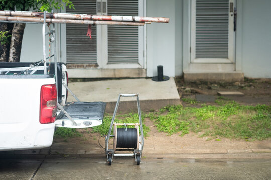 Pickup Car With Opened Truck And Wooden Ladder And Roll Wires For Repair Wires