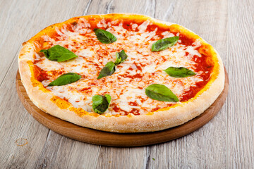 pizza margarita on wooden background top view