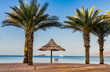 Sandy beach and relaxing atmosphere at central public beach in Eilat - famous tourist resort and recreational city in Israel 