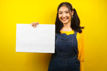 Fototapeta na wymiar Pretty and cute young woman cheerful holding blank empty banner, placard, white board, blank sign board, white advertisement board, presenting something in copy space, promotion