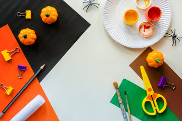 Cuts of paper for Halloween. Hand cut paper. Pumpkins. Scissors and glue. On a light background. Top view.